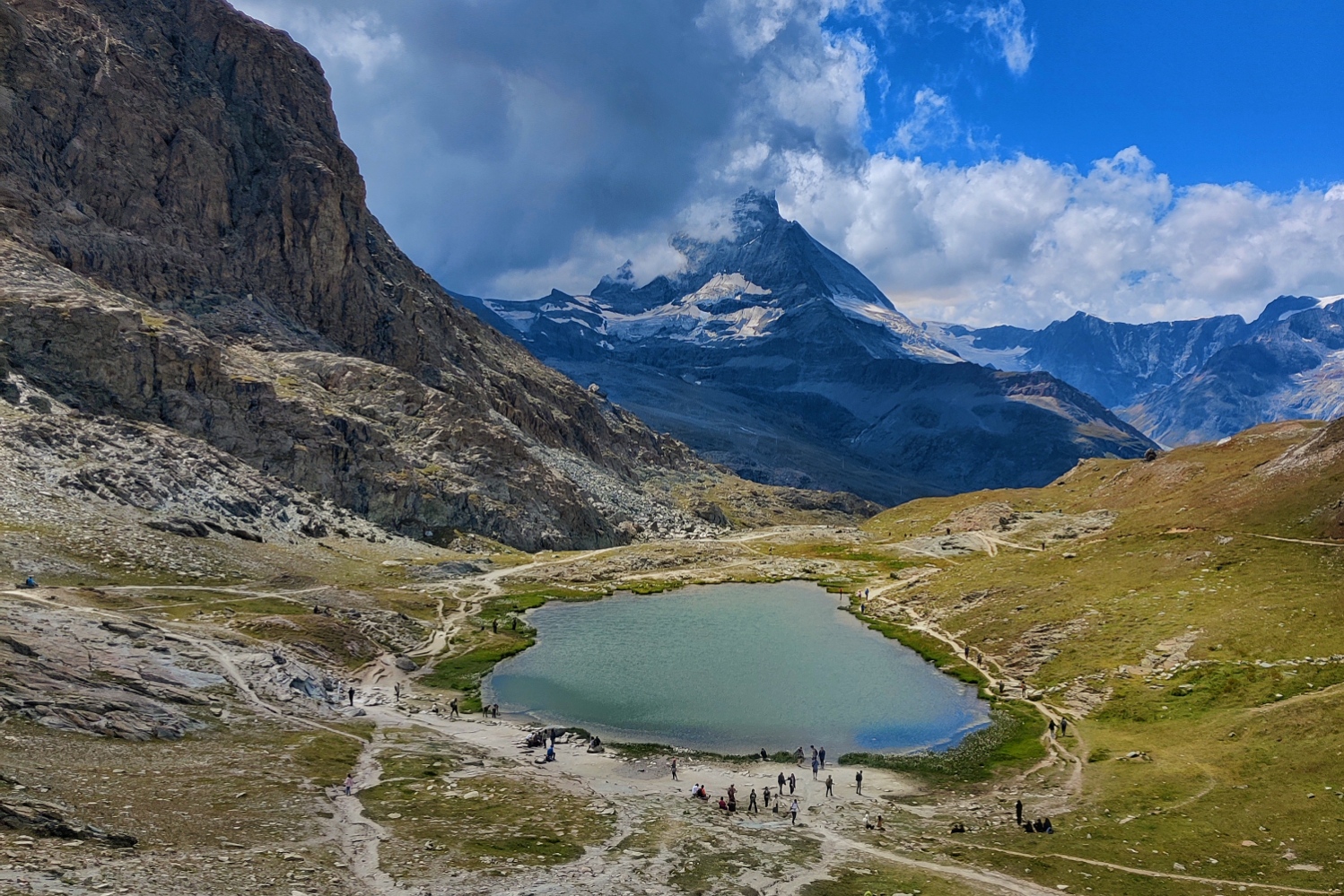 Professional photographer capturing a surprise marriage proposal at Sunnegga terrace, Zermatt.