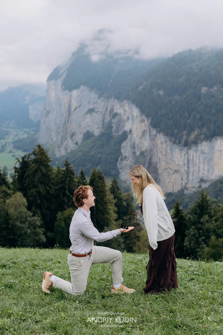 Swiss Alps proposal with ring box on a misty hillside, captured by a switzerland proposal photographer.