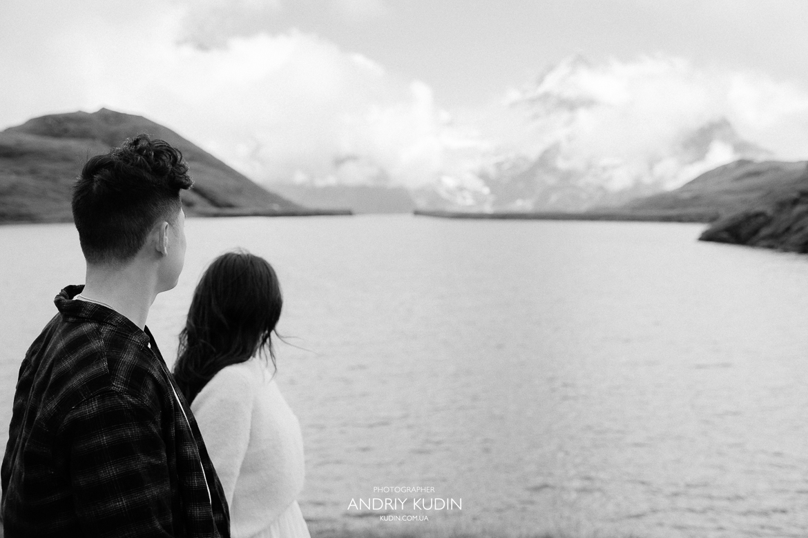 Romantic proposal scene at Grindelwald First with lake reflections