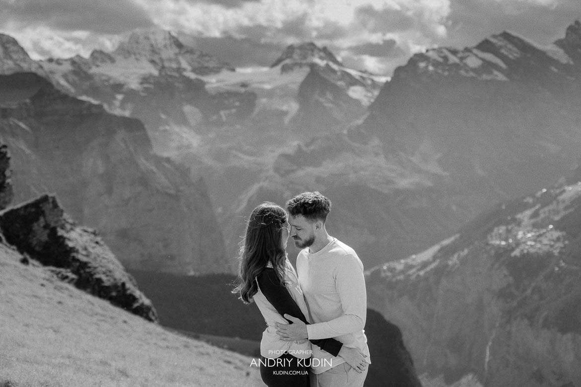 Proposal Photography in Interlaken, Couple holding hands in Lauterbrunnen Valley with Staubbach Falls behind them.