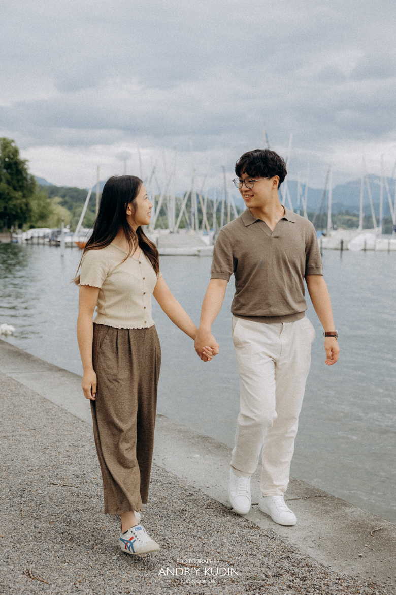 Couple during engagement photoshoot Switzerland by Lake Luzern promenade