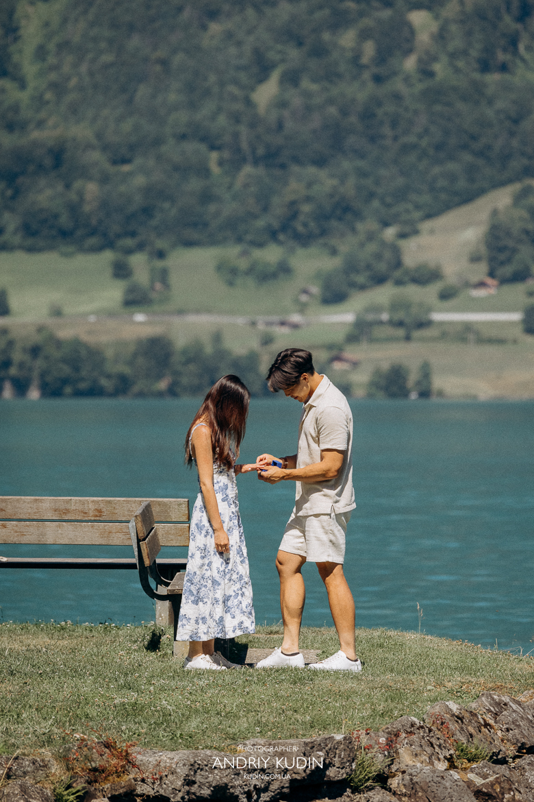 Couple proposing on Iseltwald wooden pier with Lake Brienz view. Marriage proposal photoshoot in Iseltwald, Switzerland. Engagement moment in Iseltwald with Brienzer Rothorn mountain
