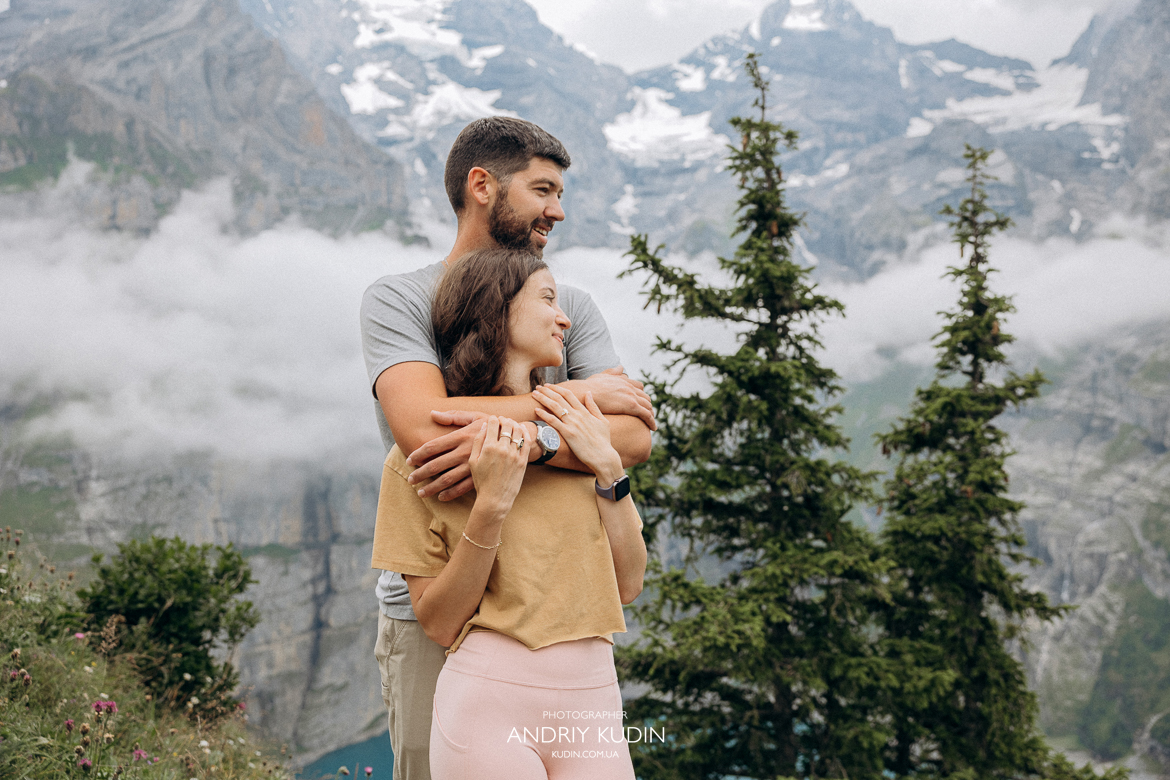 Emotional-proposal-at-Oeschinensee-lookout-with-snow-capped-Alps-background