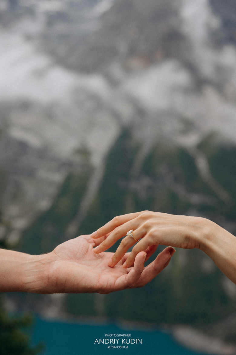 Emotional-proposal-at-Oeschinensee-lookout-with-snow-capped-Alps-background