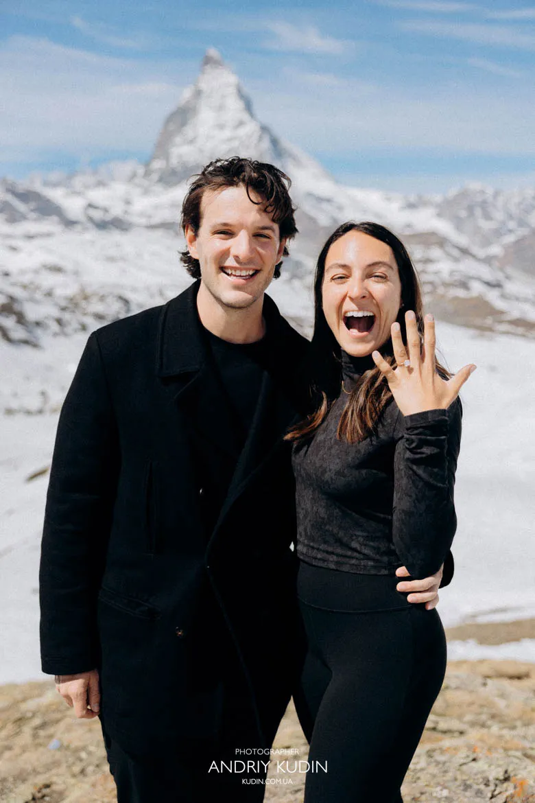 Happy engaged couple portrait for matterhorn proposal by proposal photographer switzerland