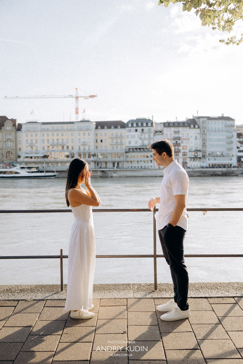 Man proposing at golden hour by Rhine River in Basel, Switzerland