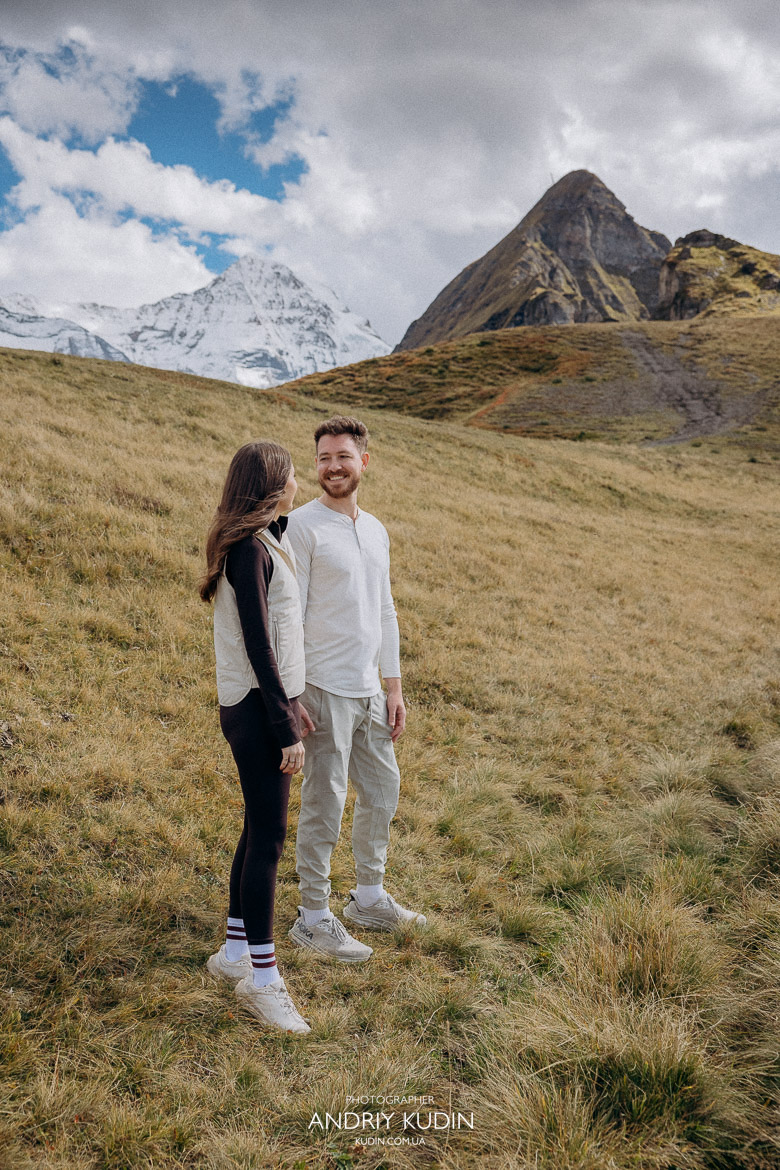 Couple holding hands after proposal in Alps