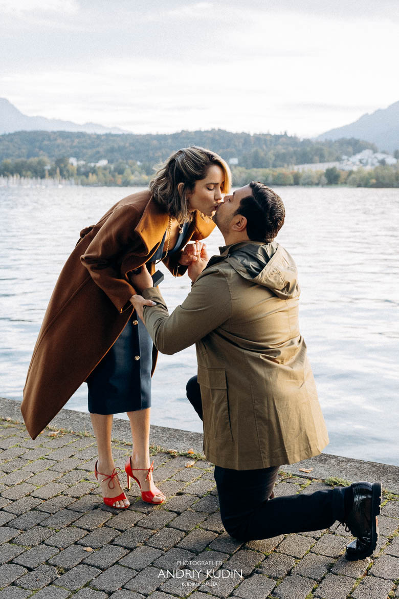 Couple proposing near Lake Zurich with mountains in view