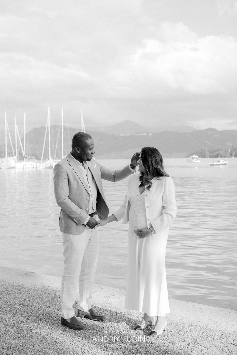 Romantic lakeside proposal with sailboats in the background