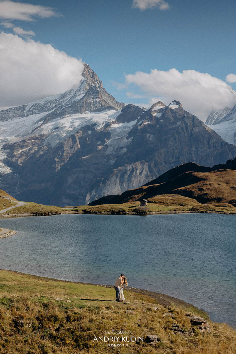 Romantic proposal in the Swiss Alps with snowy mountains in the background.