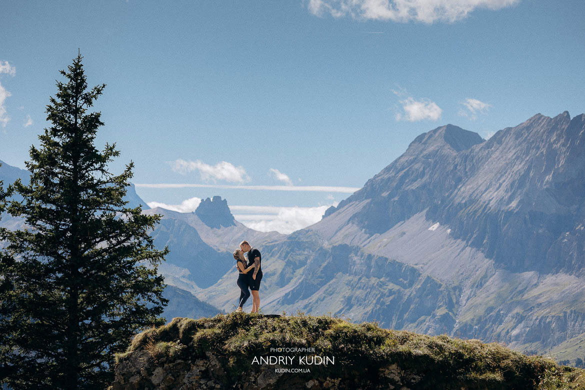 Cinematic proposal moment at Lake Oeschinen featuring a Tiffany engagement ring and mountain panorama.