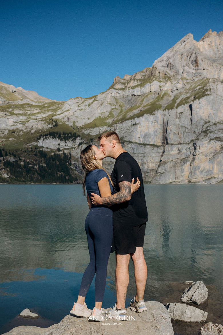 Swiss Alps proposal at Lake Oeschinen with a man placing a Tiffany ring on his girlfriend’s hand