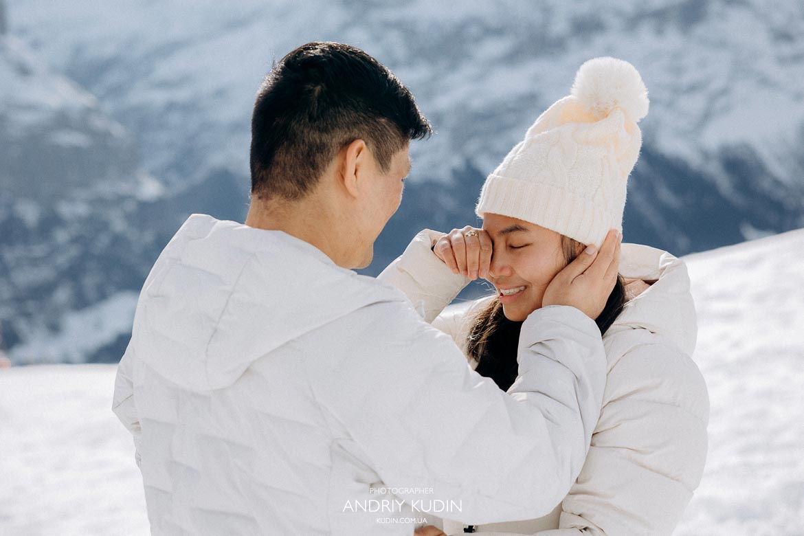 Marriage proposal in Switzerland with snowy mountains and alpine views
