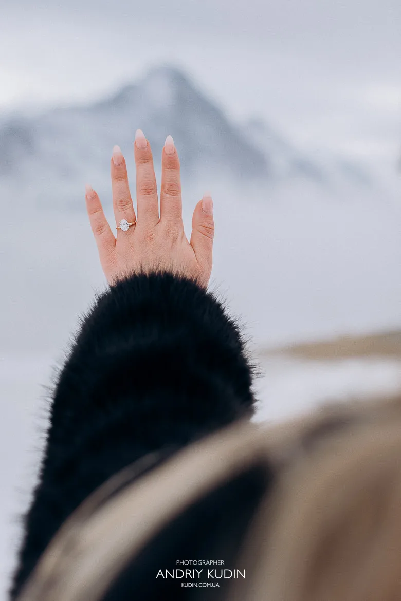Proposal in Switzerland on Grindelwald First surrounded by fog and snowy mountains
