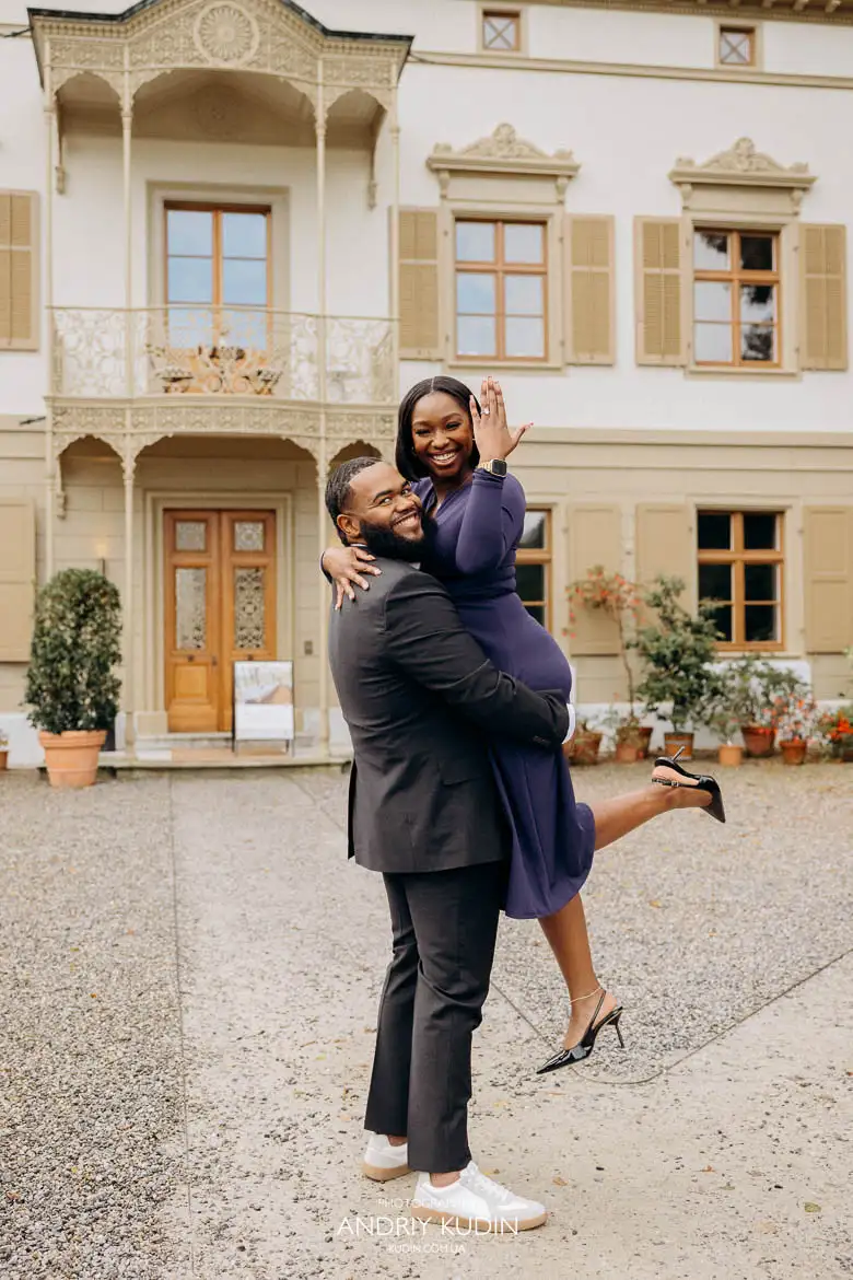 Romantic proposal in Zurich as he holds her in his arms while she shows her engagement ring with happiness Romantic proposal in Zurich as he holds her in his arms while she shows her engagement ring with happiness