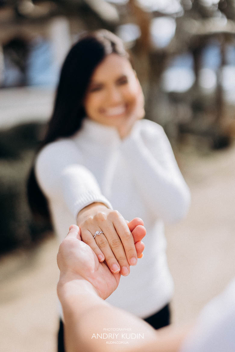 Bride-to-be showing her engagement ring after romantic proposal in Luzern with Lake Lucerne and Swiss Alps behind