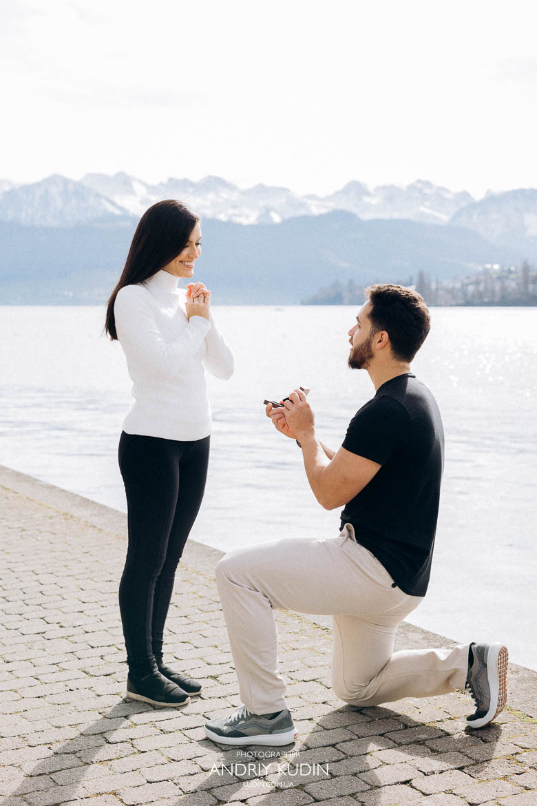 Surprise proposal in Luzern captured with turquoise lake and snow-capped mountains, Groom holding ring box moments before romantic proposal in Luzern Surprise proposal in Luzern captured with turquoise lake and snow-capped mountains, Groom holding ring box moments before romantic proposal in Luzern