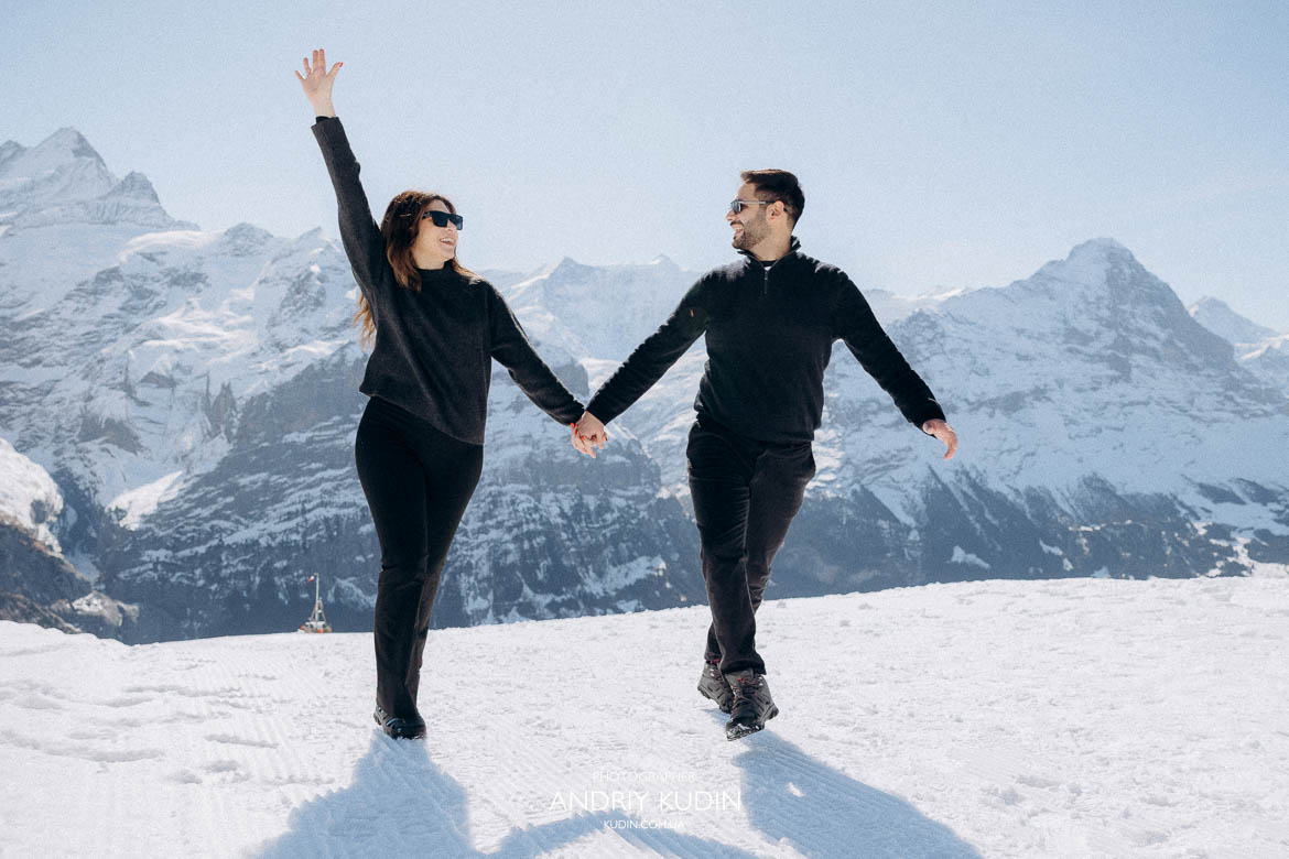 couple enjoying Swiss winter view, snowy Alps romantic couple moment