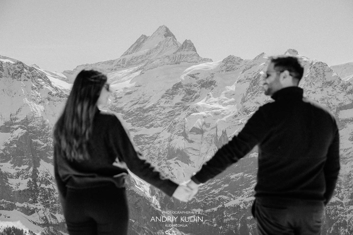 winter love story Swiss mountains, couple enjoying snowy alpine view