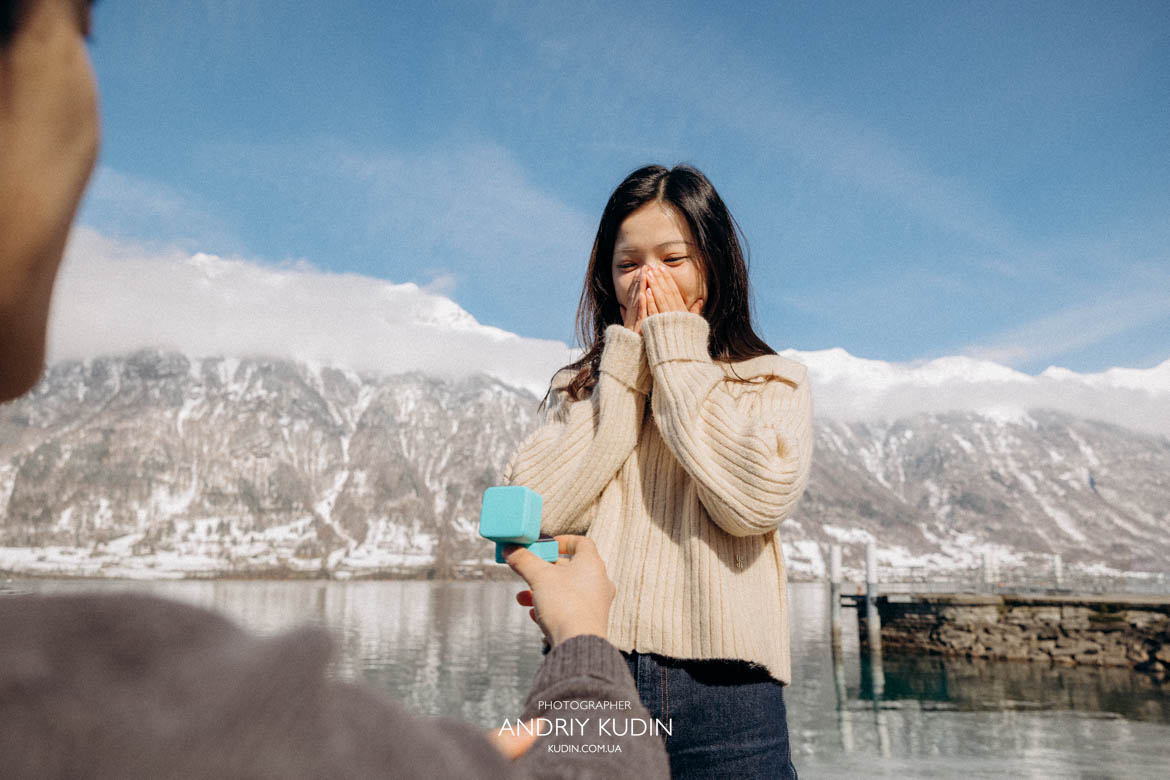 Surprise engagement captured at Iseltwald Pier during a romantic proposal in Switzerland