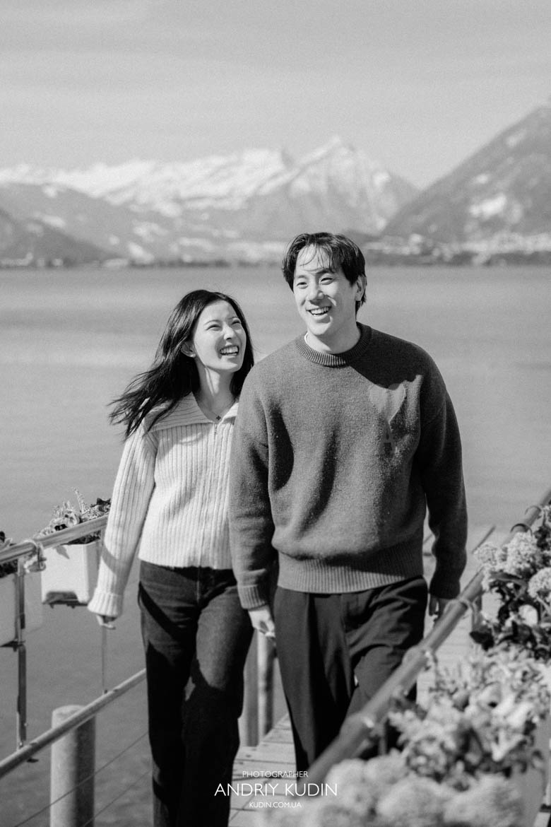 Couple laughing after surprise proposal in Switzerland near Lake Brienz Couple laughing after surprise proposal in Switzerland near Lake Brienz