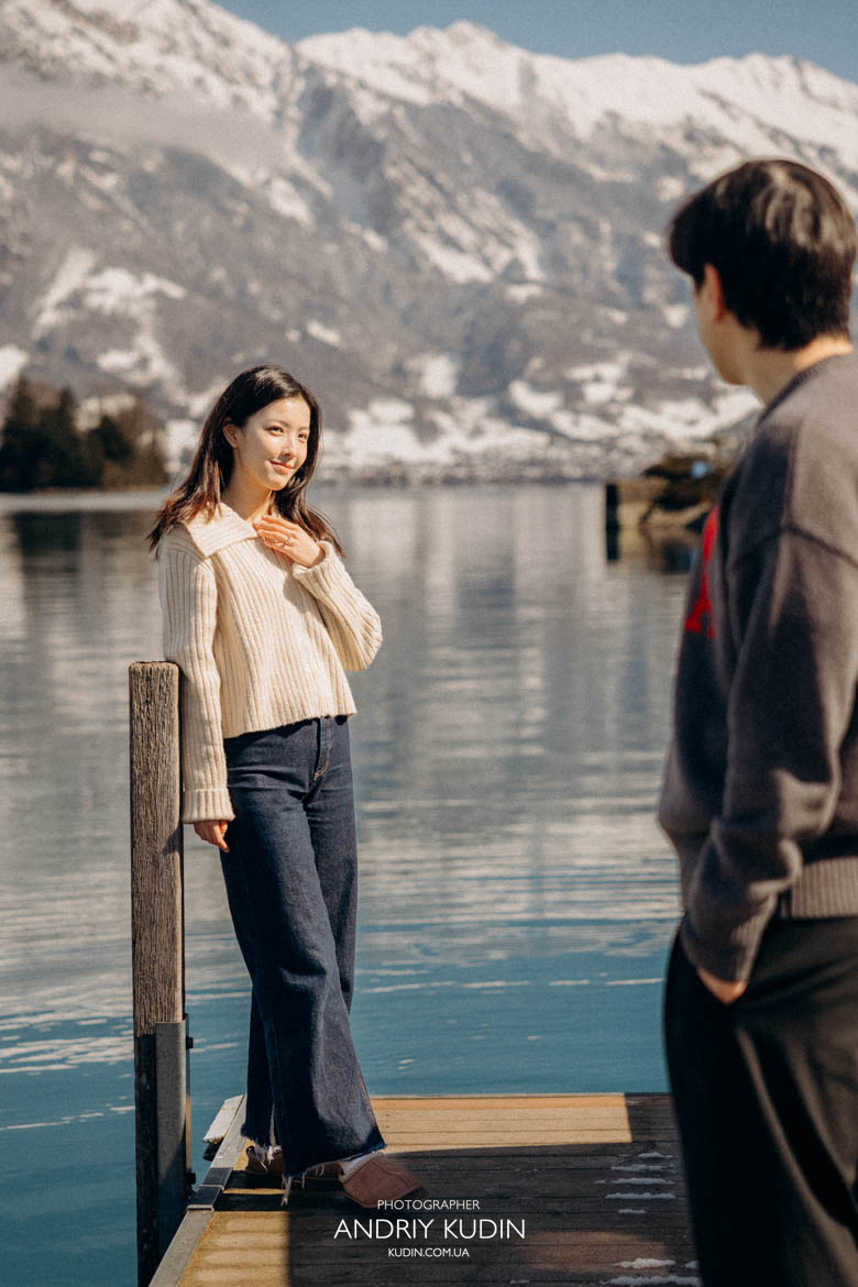 Couple enjoying sunset after proposal in Iseltwald Switzerland with golden light