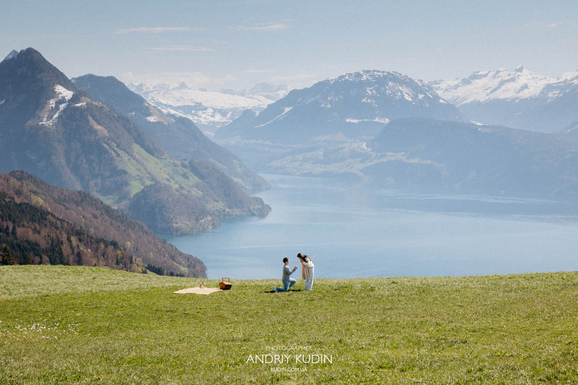 Couple enjoying apero setup at Villa Honegg with Lake Lucerne view Switzerland Romantic picnic with champagne at Villa Honegg overlooking Swiss Alps