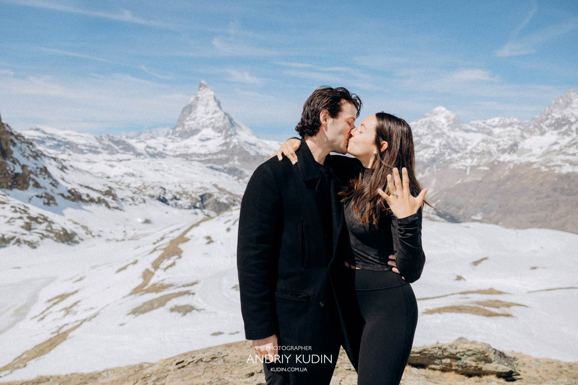 couple laughing after proposal swiss alps, stylish outfit engagement switzerland mountains