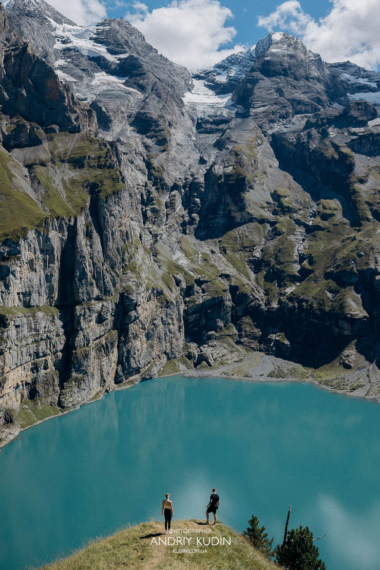Emotional engagement moment at Lake Oeschinen with alpine landscape