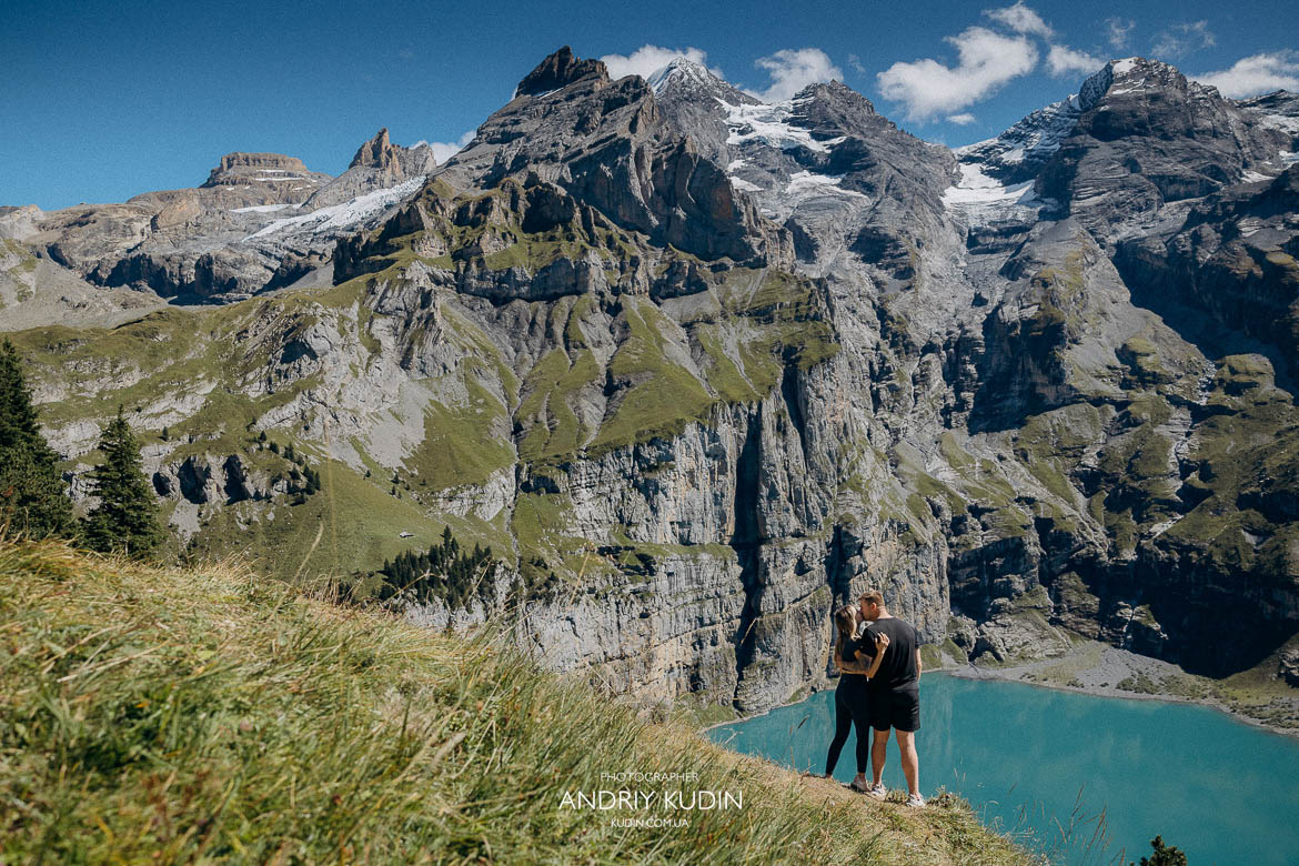 switzerland proposal photographer capturing romantic mountain engagement Oeschinensee engagement photos with turquoise lake and Swiss Alps