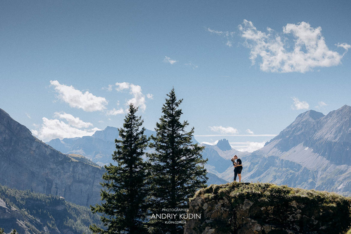 Couple hugging after engagement at Oeschinensee mountain lake Luxury Switzerland proposal session at Lake Oeschinensee