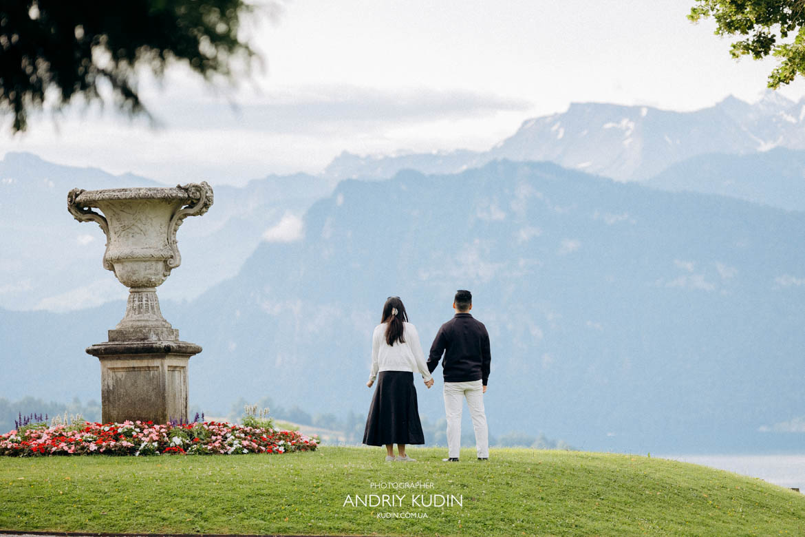 Romantic engagement scene at sunrise on an elevated terrace overlooking the city of Lucerne.