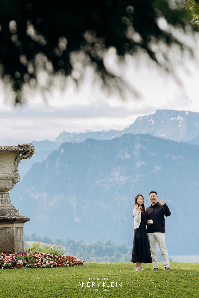 Epic proposal shot featuring the dramatic peak of Mount Pilatus behind the kneeling couple. Romantic morning proposal with no tourists around in a scenic park above Lucerne city. Epic proposal shot featuring the dramatic peak of Mount Pilatus behind the kneeling couple. Romantic morning proposal with no tourists around in a scenic park above Lucerne city.