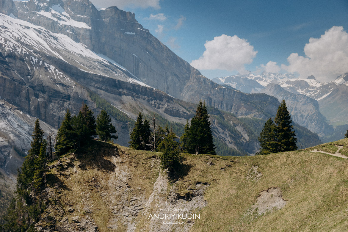 Alpine lake proposal Switzerland showcasing crystal clear blue water and mountains.