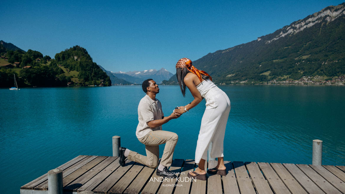 Man kneeling for an Iseltwald engagement session in the soft afternoon light. Best places to propose in Switzerland featuring a romantic couple at Lake Brienz.