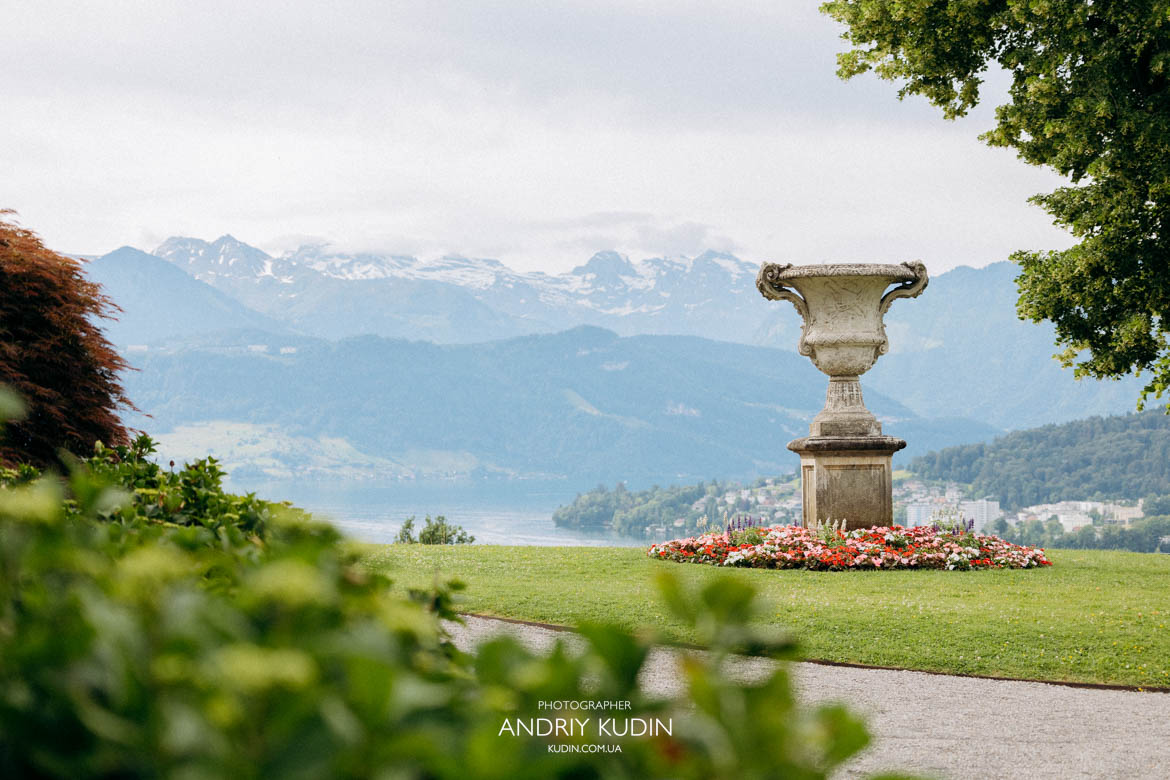Wide shot of a couple alone in a hilltop park during a romantic Swiss engagement. Wide shot of a couple alone in a hilltop park during a romantic Swiss engagement.