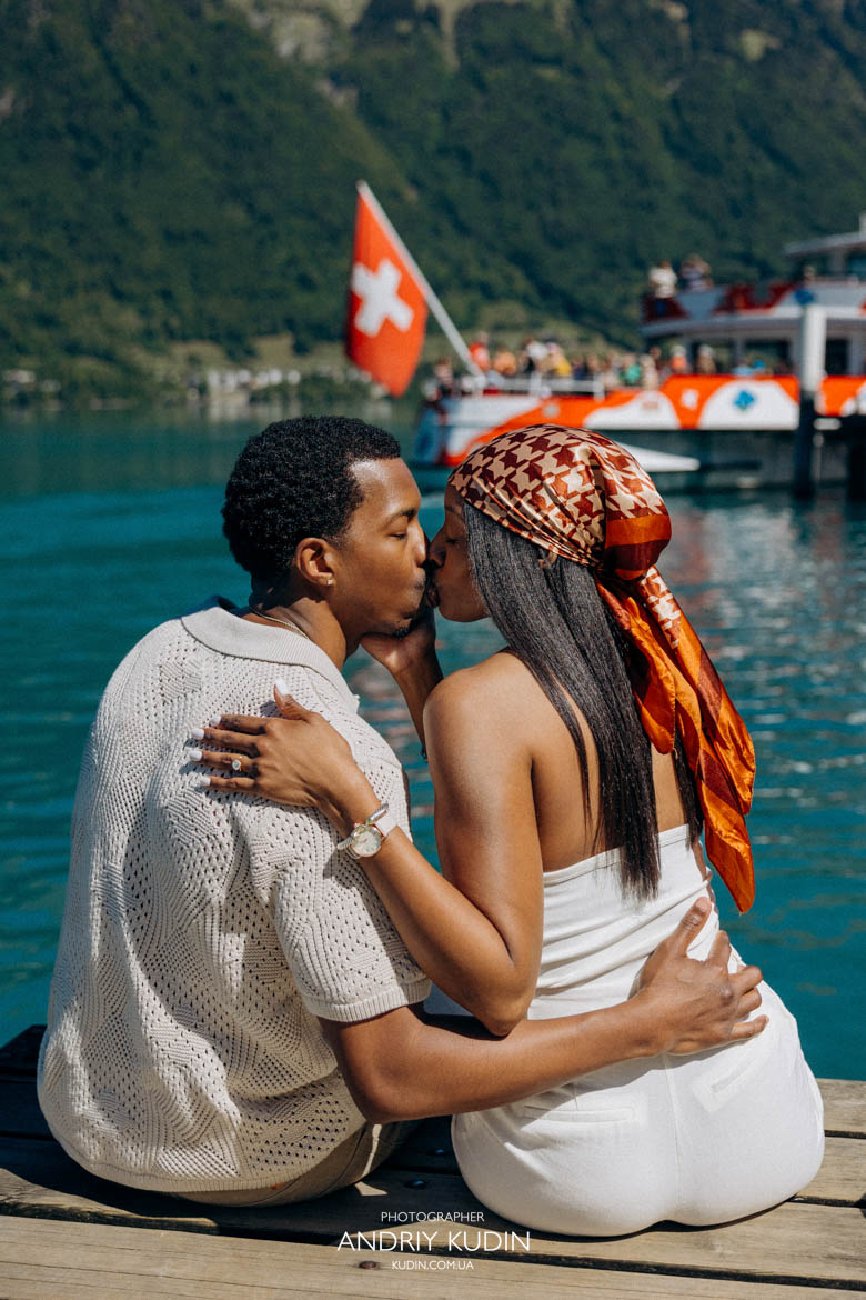 Surprise proposal Swiss Alps backdrop with a happy couple hugging in Iseltwald.