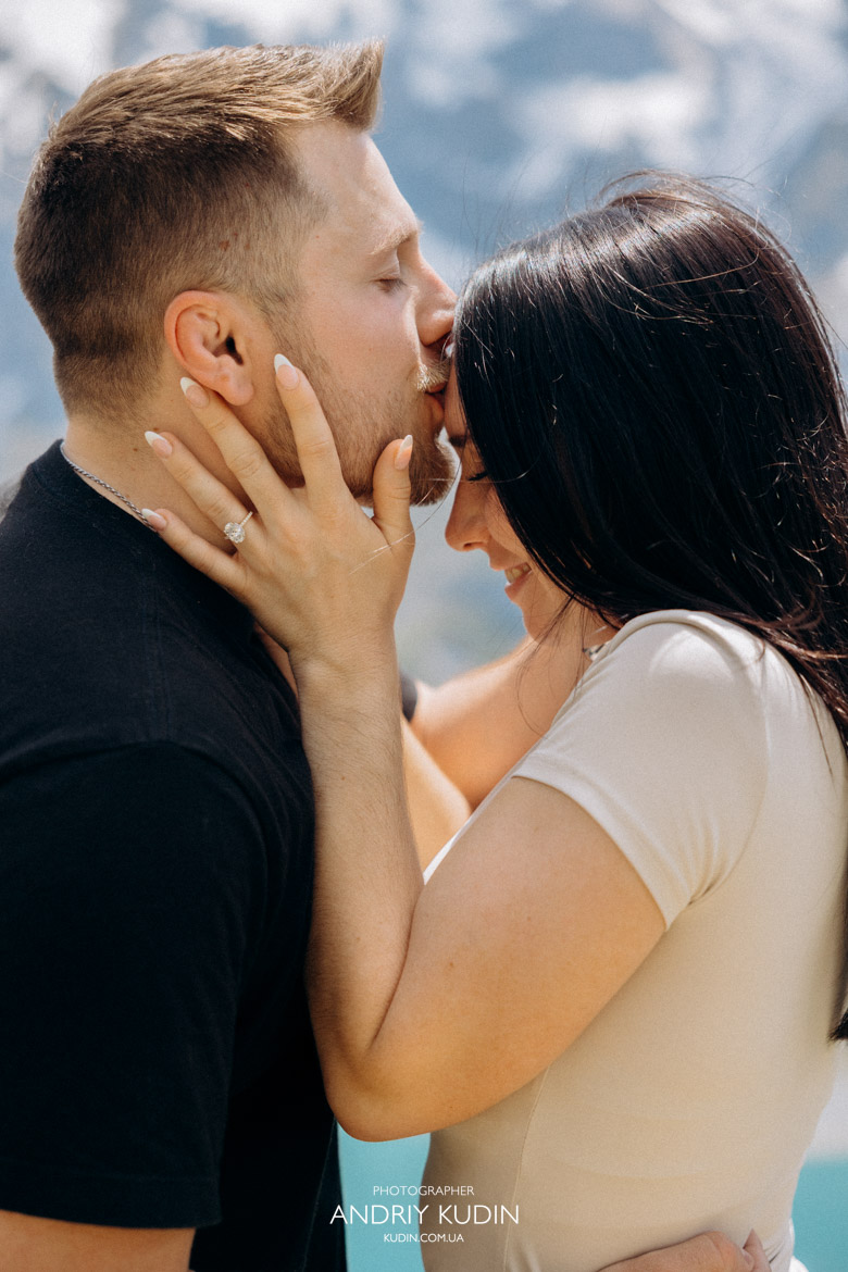 Romantic proposal Switzerland style at the scenic Oeschinensee waterfront.