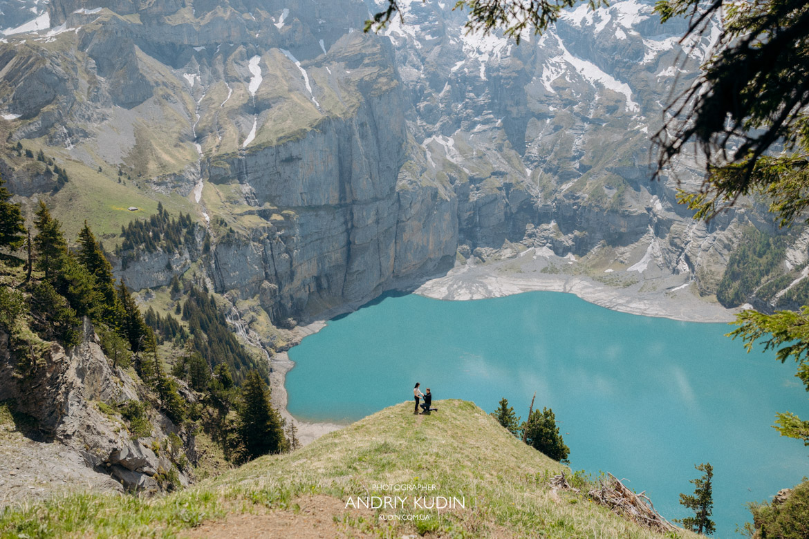 Romantic proposal Switzerland style at the scenic Oeschinensee waterfront.
