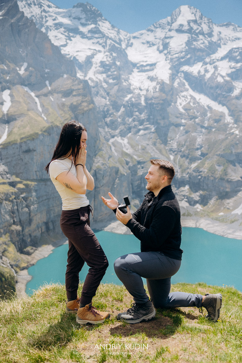 Romantic proposal Switzerland style at the scenic Oeschinensee waterfront.