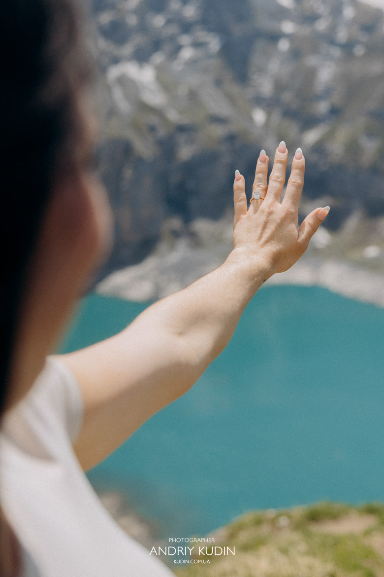 Proud Switzerland proposal photographer capturing a couple hugging and celebrating their engagement.