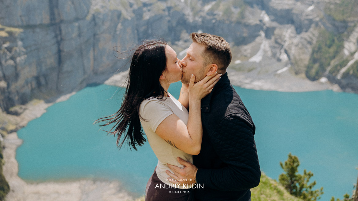 Romantic proposal Switzerland style at the scenic Oeschinensee waterfront.