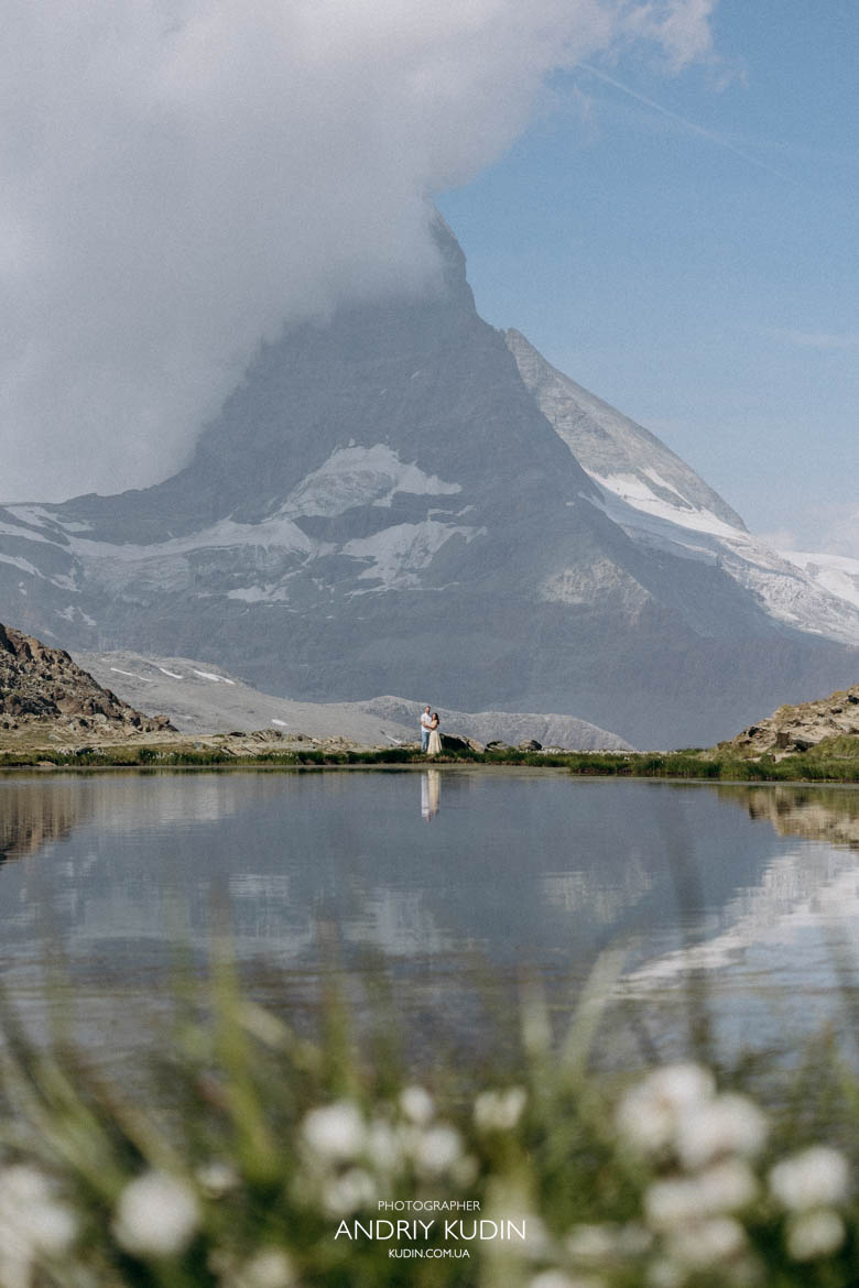 The mirror-like surface of Lake Riffelsee perfectly captures the Matterhorn Switzerland proposal photographer documenting a Matterhorn proposal. The mirror-like surface of Lake Riffelsee perfectly captures the Matterhorn
