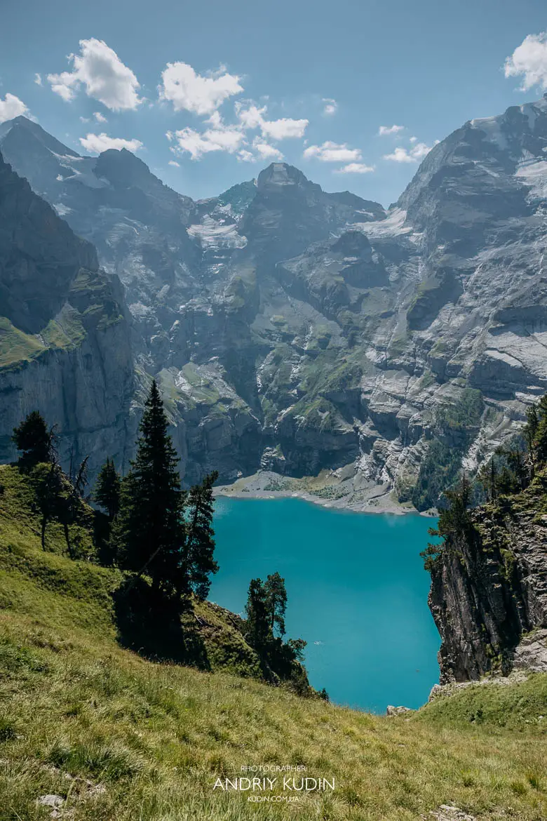 Panoramic turquoise water of Lake Oeschinensee framed by Swiss Alps mountains captured by Switzerland proposal photographer