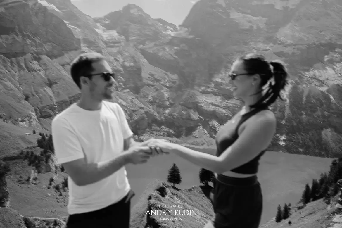 Engagement portrait session on mountain ridge overlooking Lake Oeschinensee
