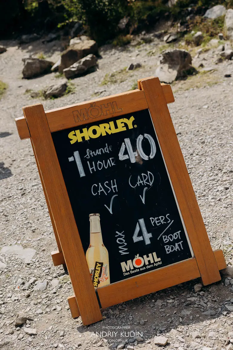 Lake Oeschinen boat rental price sign showing 40 CHF per hour rate and maximum 4 people capacity