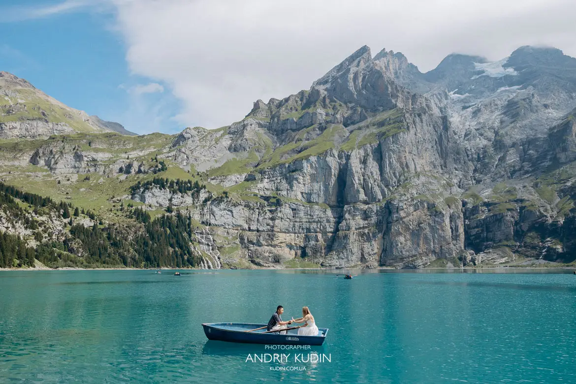 Emotional surprise marriage proposal moment on a wooden rowboat in Lake Oeschinen Switzerland