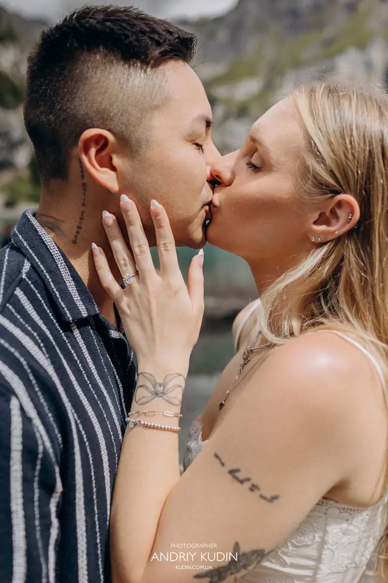 Close up portrait of newly engaged couple kissing with diamond ring visible captured by switzerland proposal photographer