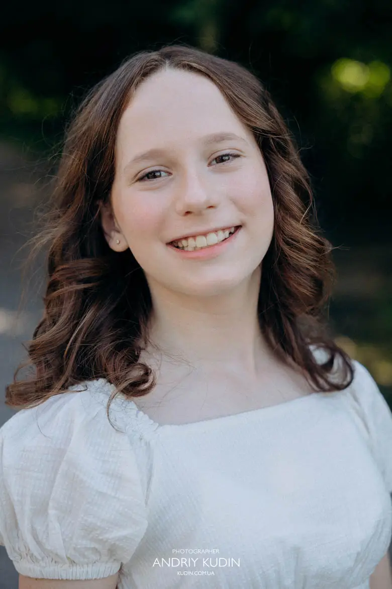 Close up outdoor portrait of teenage girl smiling during family photo session in Switzerland