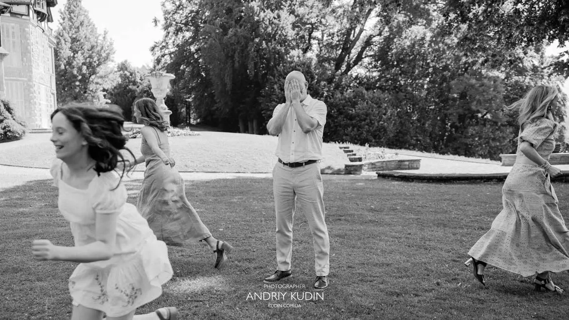 Playful family playing hide and seek outdoors during family photo session in Switzerland